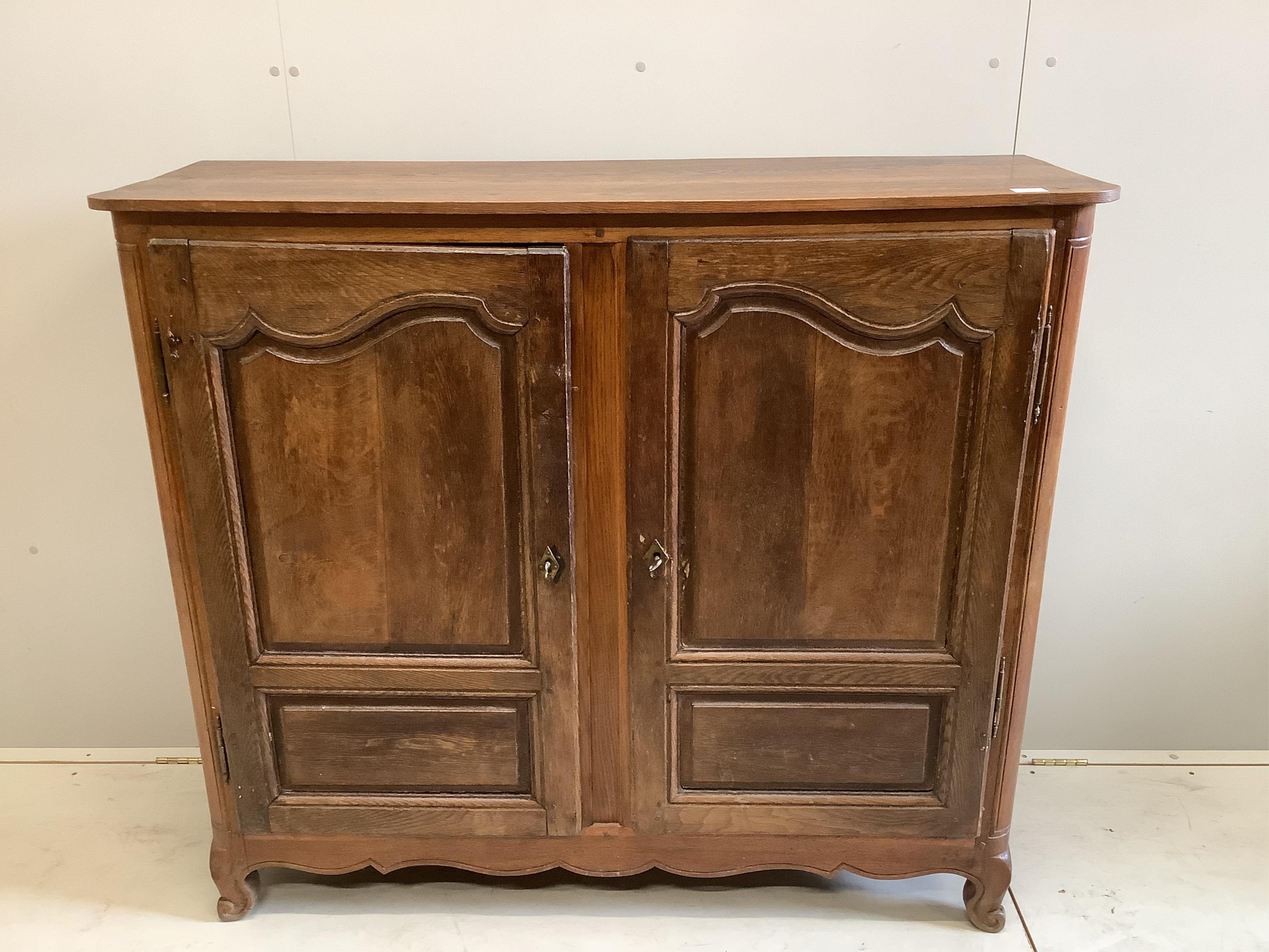 An 18th century French oak two door cupboard, width 134cm, depth 46cm, height 118cm
